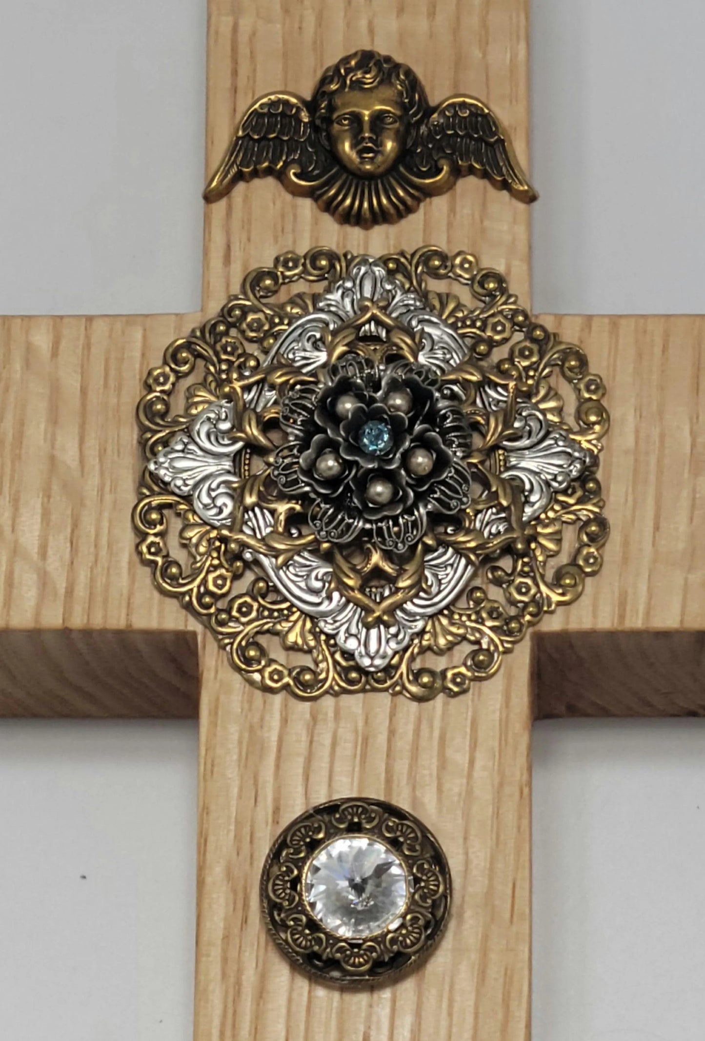 Ornate jeweled oak cross wall decor with gold and silver medallion and angel accent