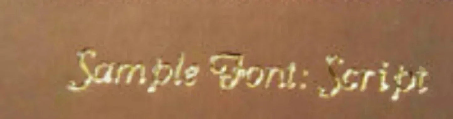 Gold script embroidery sample font on brown background, personalized gift detail
