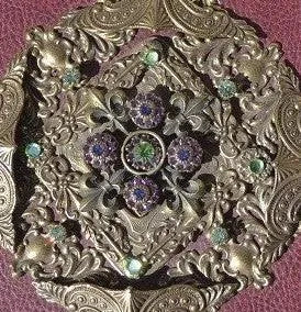 Close-up of ornate jeweled Bible cover with intricate gold design and colorful gemstones