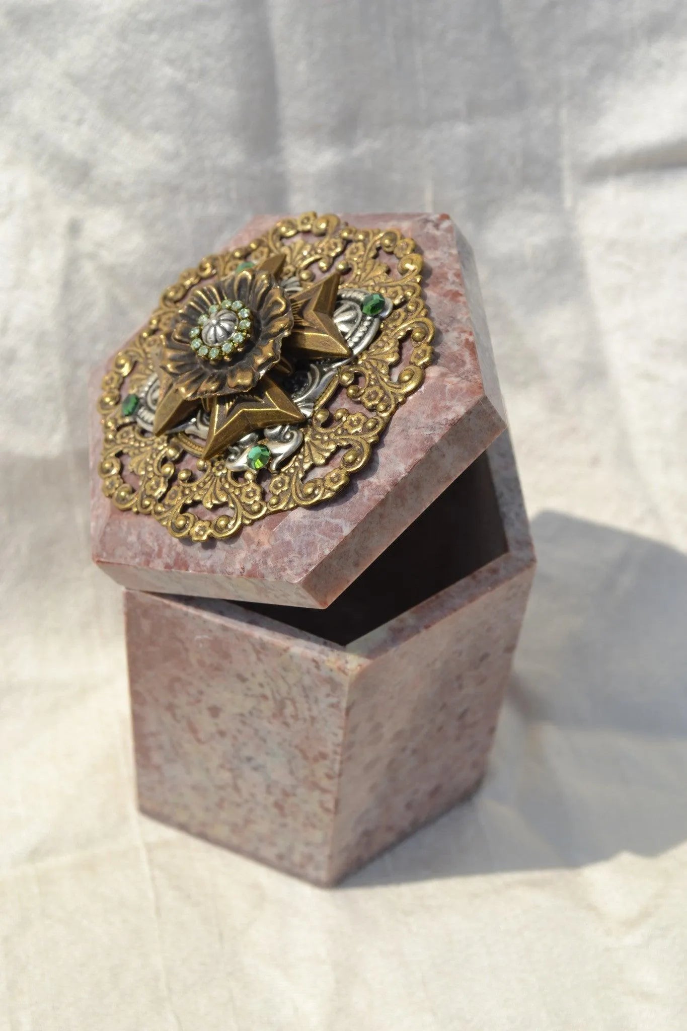 Open hexagonal keepsake box with jeweled Maltese cross and ornate gold accents