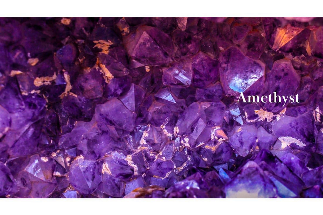 Close-up of purple amethyst crystal cluster with jagged facets and gold accents