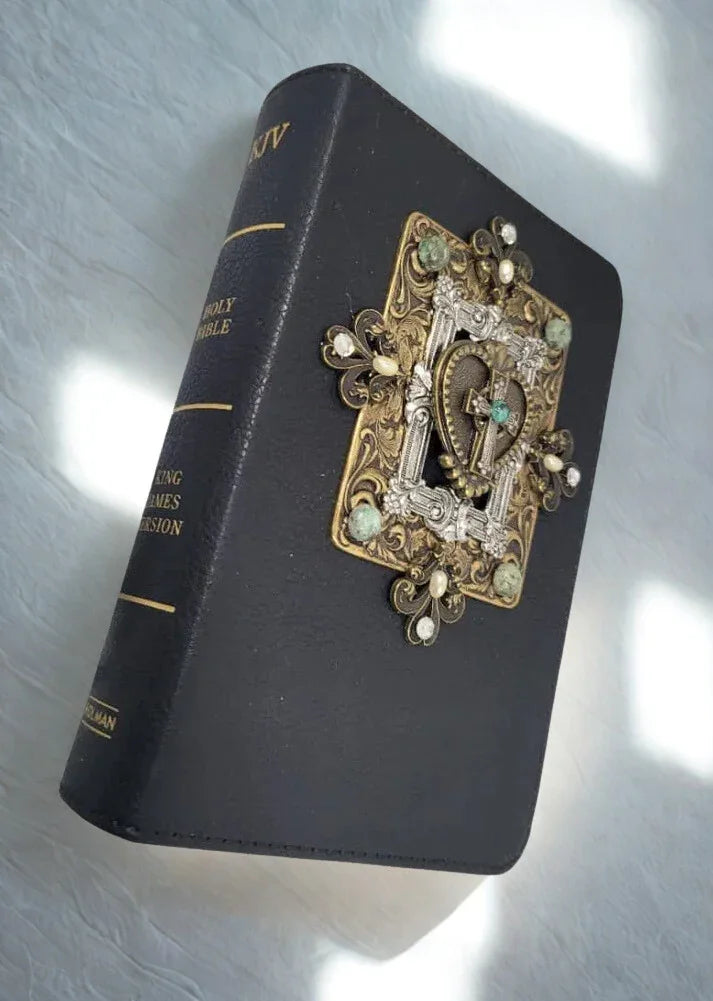 Jeweled black Holy Bible with ornate metal and gemstone embellishments on cover
