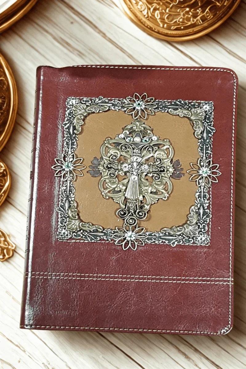 Jeweled leather-bound Bible with ornate floral cross and decorative silver accents on cover