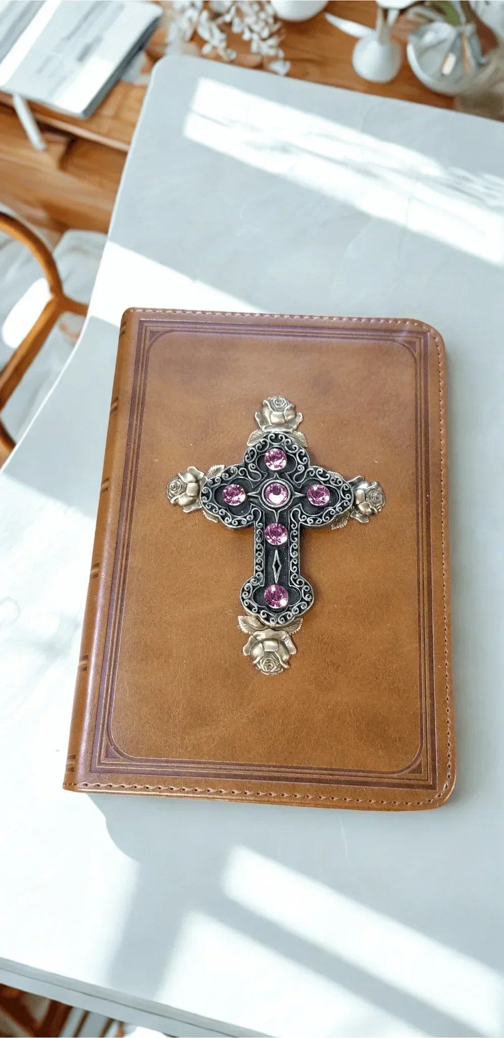 Tan leather keepsake Bible with jeweled cross and pink gemstones on cover