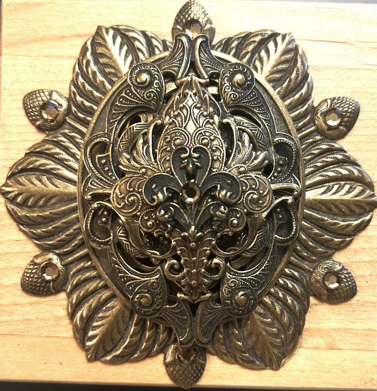 French-inspired jeweled wooden keepsake box with ornate metal floral decor close-up