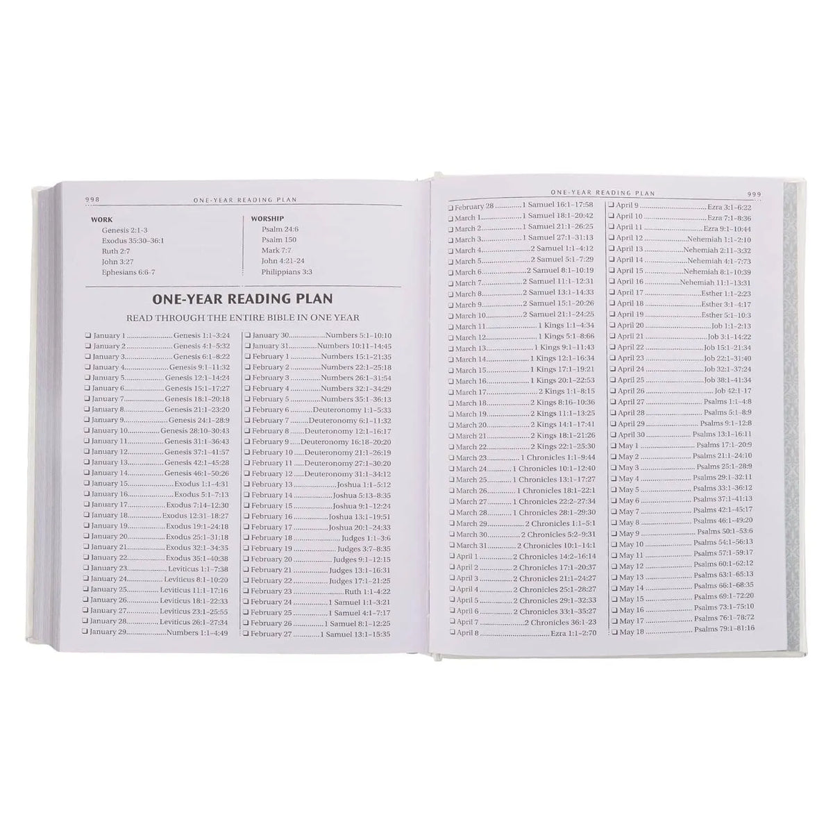 Open white faux leather Bible displaying a one-year Bible reading plan on both pages