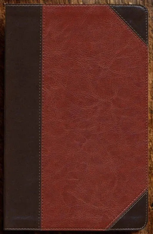 Closeup of a brown faux leather Bible cover with textured detail on wood surface