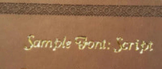 Gold script font sample embossed on brown leather background with decorative border