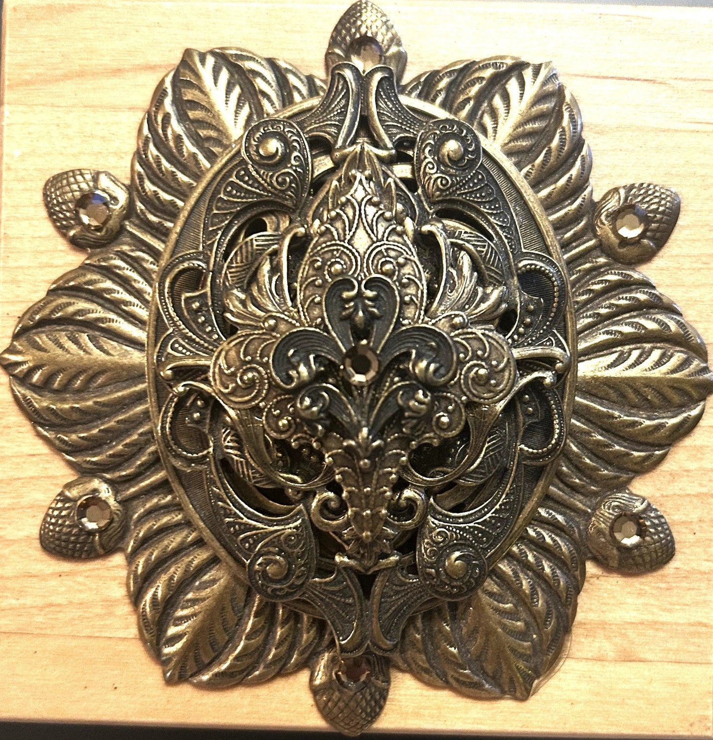French-inspired jeweled wooden keepsake box with ornate metal floral decor close-up