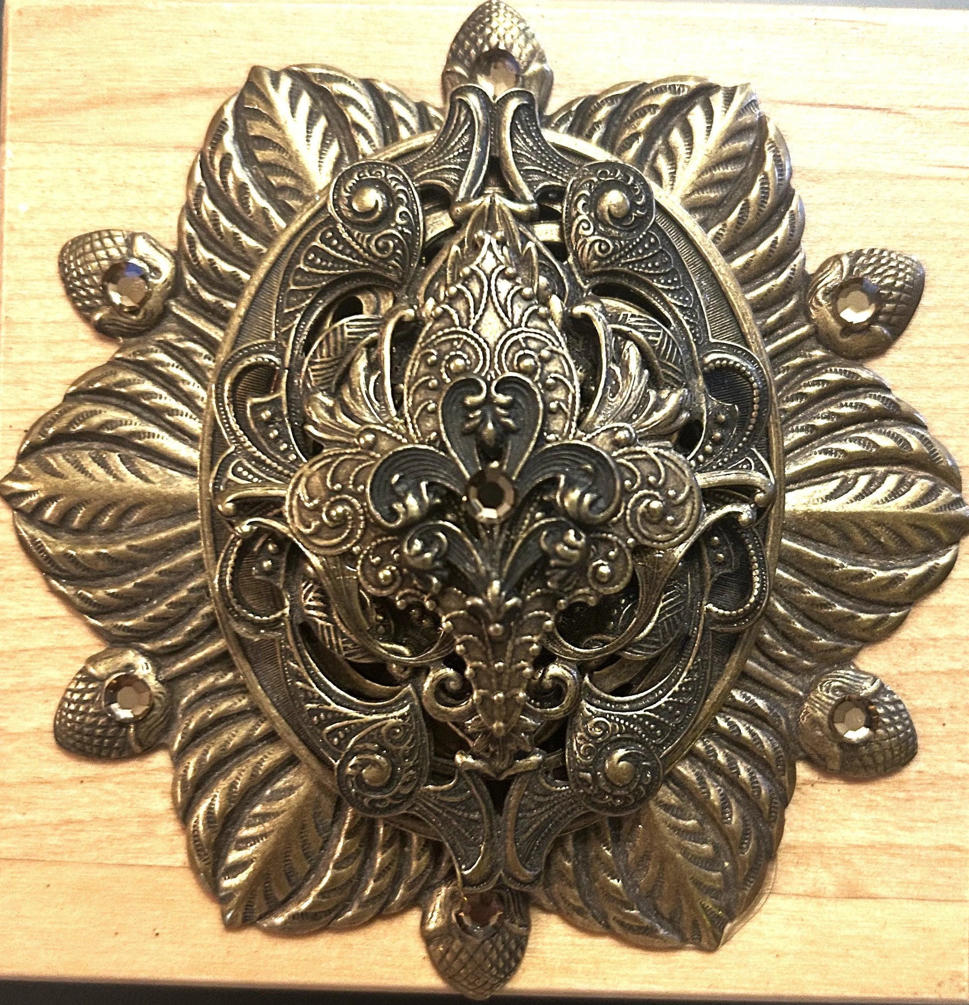 French-inspired jeweled wooden keepsake box with ornate metal floral decor close-up