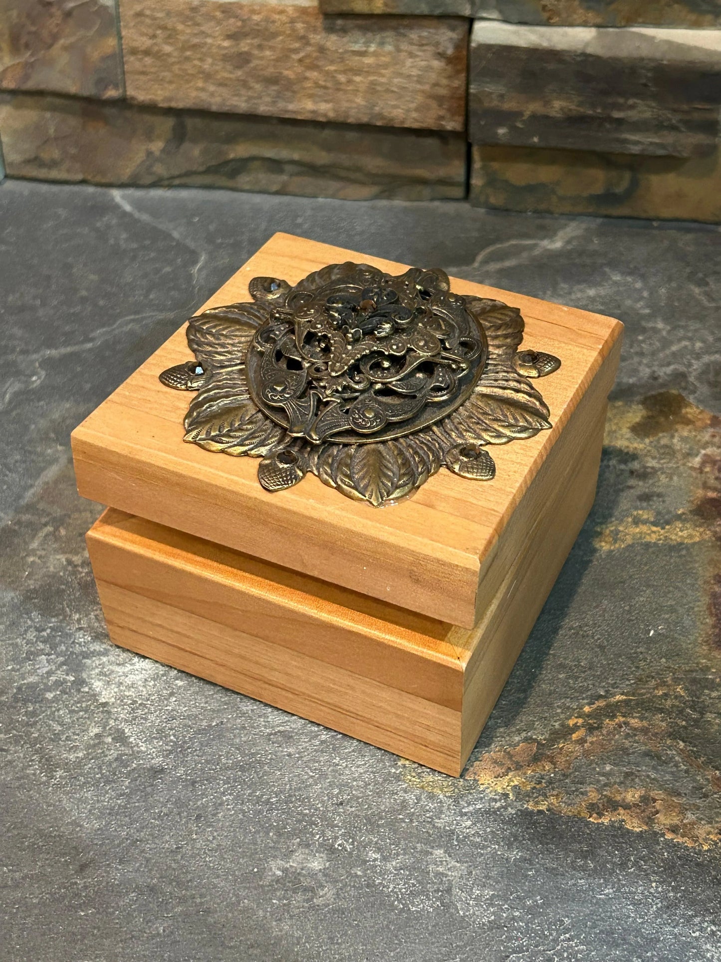 French-inspired jeweled wooden keepsake box with ornate metal floral lid, side angle view
