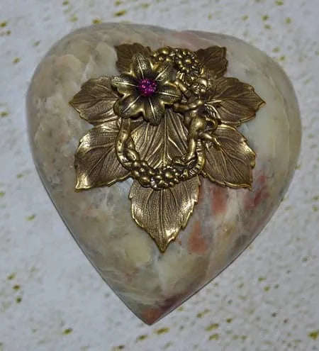 Marble heart paperweight with gold cupid, ornate leaves, and pink jeweled flower on top