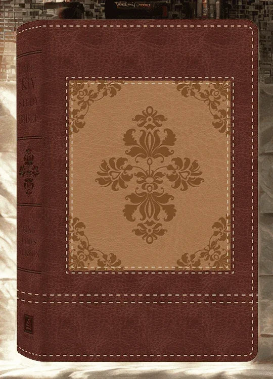Closeup of a KJV study Bible with ornate cross design on brown vegan leather cover.