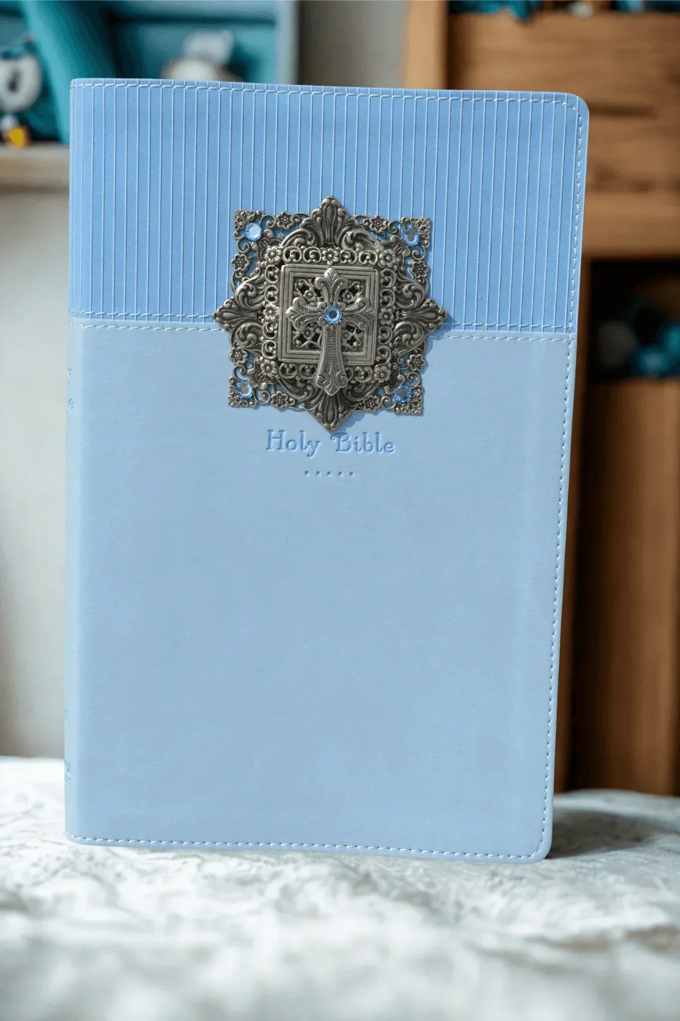 Blue baby keepsake Bible with jeweled silver cross and ornate metal accent on cover