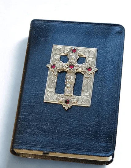 Jeweled Bible with ornate silver cross and red gemstones on black leather cover