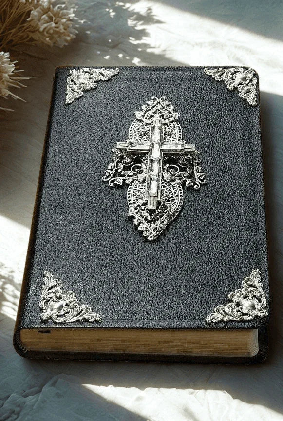 Black Bible with jeweled crystal cross and ornate silver metal corners on cover