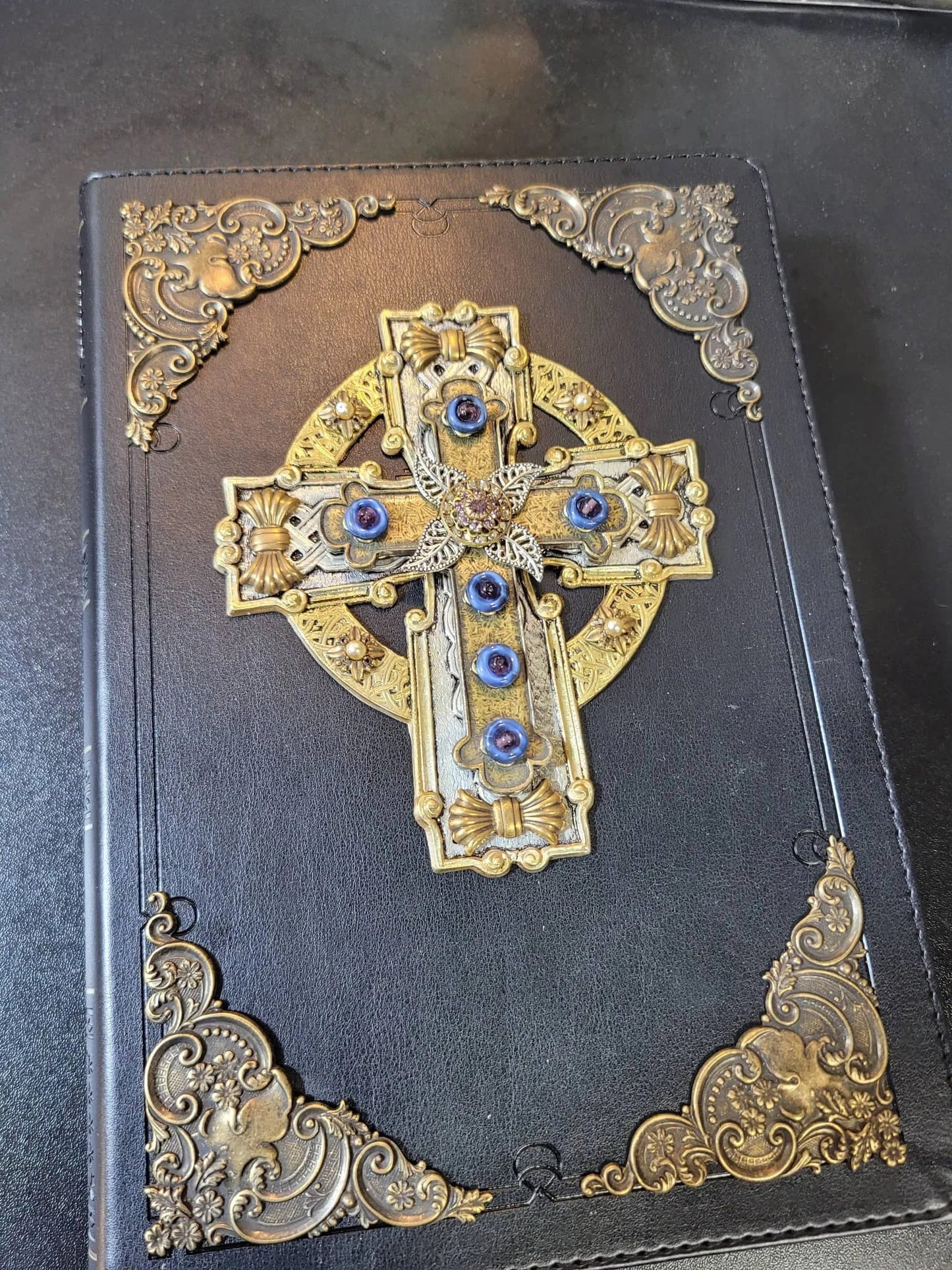 Black leather Bible with jeweled Celtic cross and ornate gold vintage accents on cover