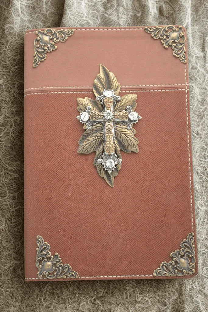Jeweled brown NIV Bible with ornate gold cross and silver accents on lace fabric background