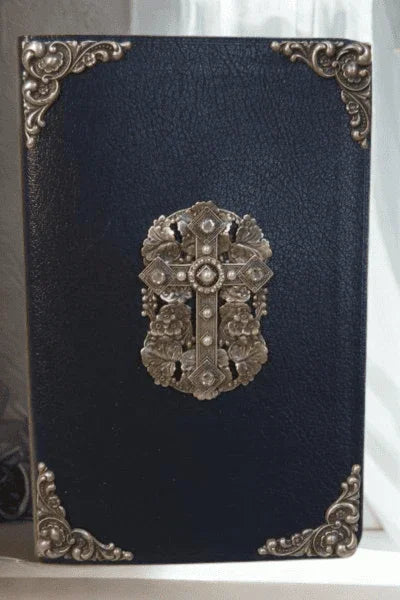 Jeweled Bible with black cover, ornate gold corners, and rhinestone cross centerpiece