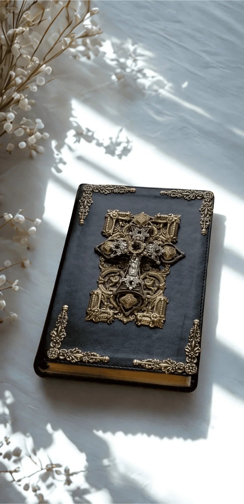 Jeweled NKJV Bible with ornate gold cross on cover, amethyst accents, in sunlight
