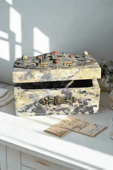 Open jeweled soapstone keepsake box with ornate detailing in natural sunlight