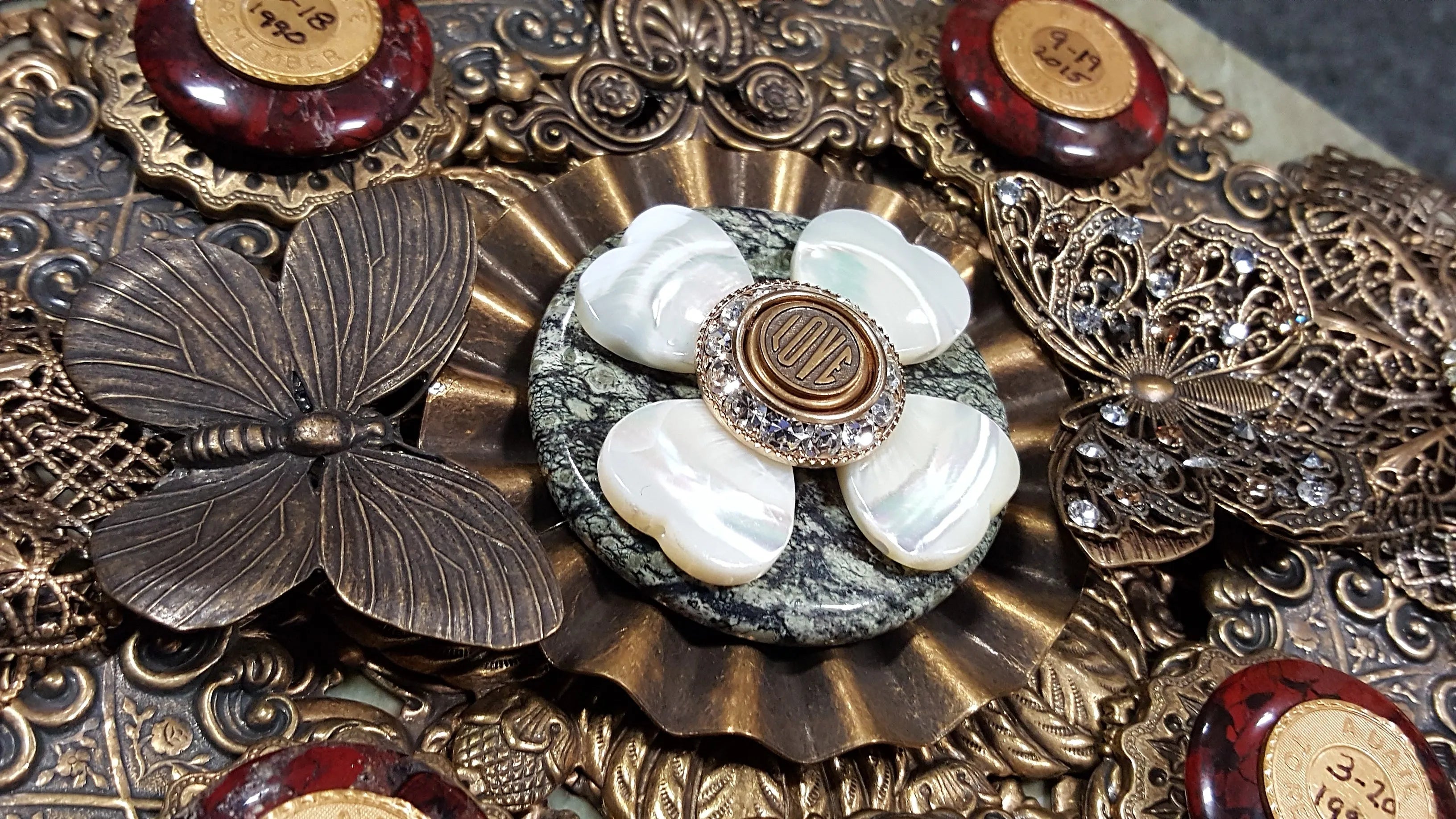 Vintage-inspired metal and jeweled butterfly, flower, and LOVE embellishments on ornate keepsake box