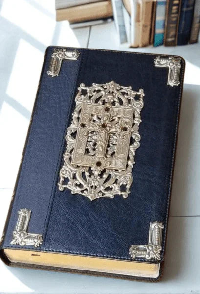 Jeweled KJV Bible with ornate silver detailing on black cover, large print, on book table