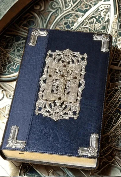 Ornate jeweled black Bible with metal gold cross and decorative cover accents