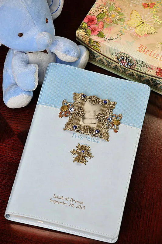 Personalized baby boy Bible with blue and white cover, photo frame, plush toy, and floral box