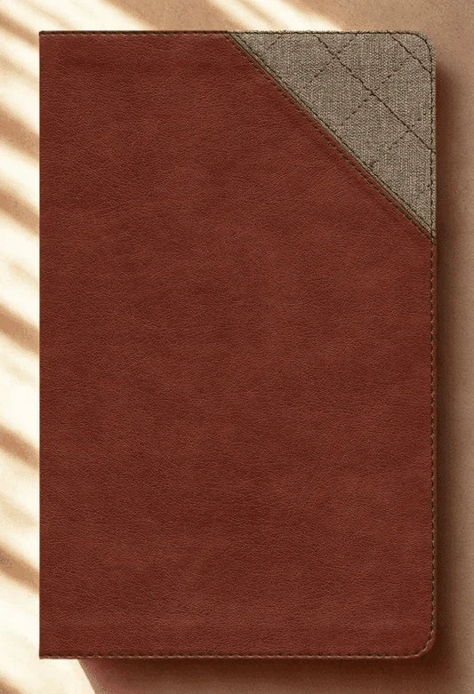 Brown faux leather Bible with textured fabric corner detail on neutral background