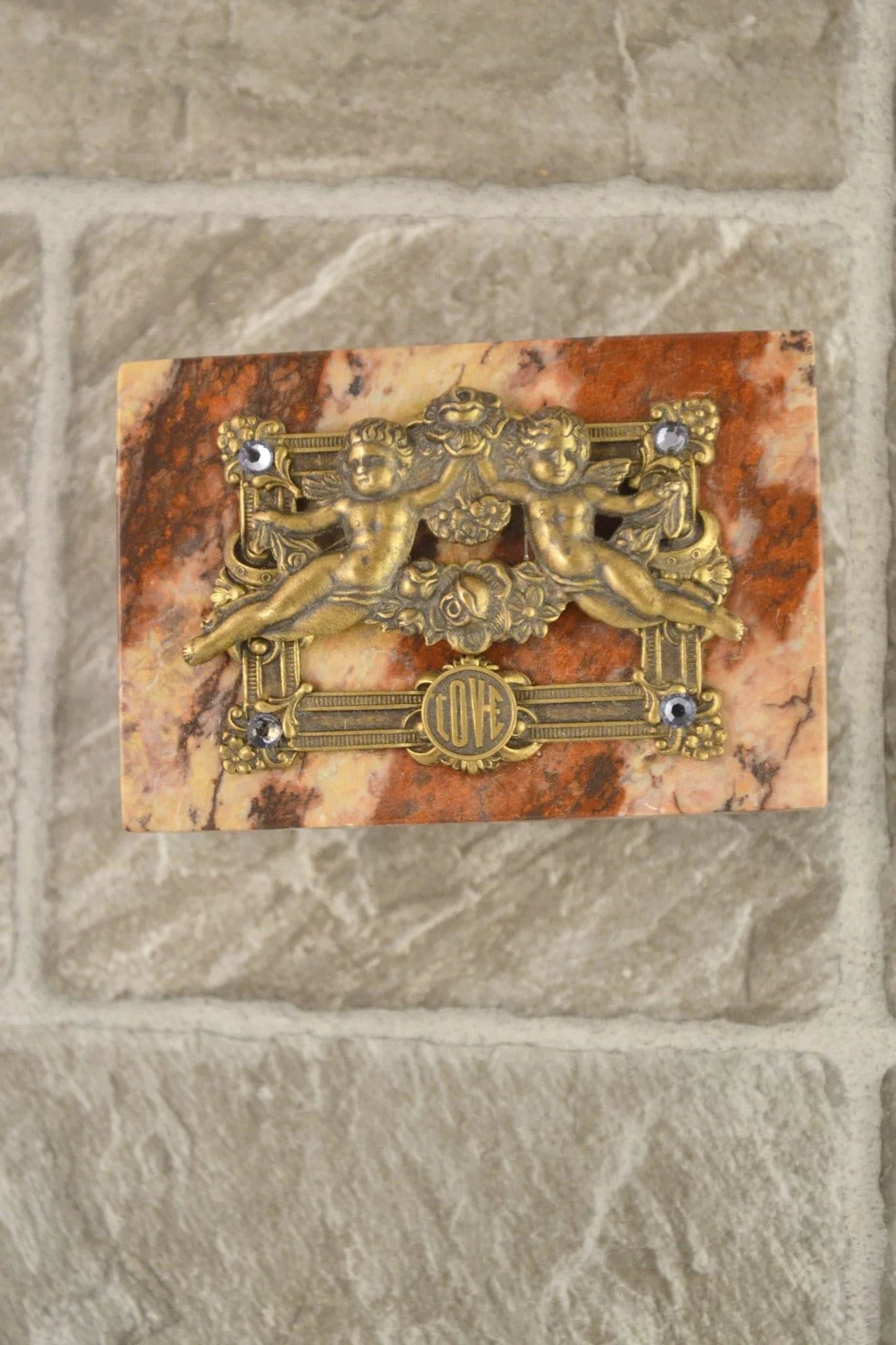 Handcrafted marble keepsake box with ornate gold cherubs, LOVE inscription, and gemstone accents