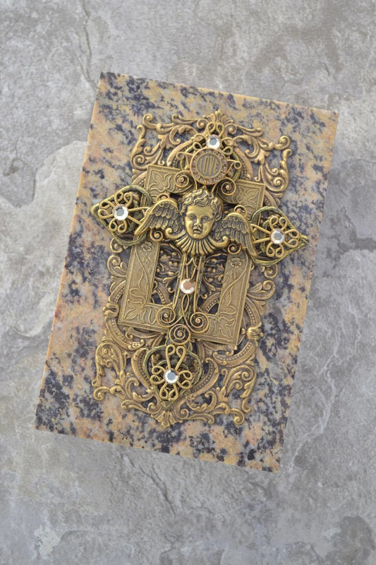 Handcrafted soapstone keepsake box with ornate gold angel cross and gemstone accents