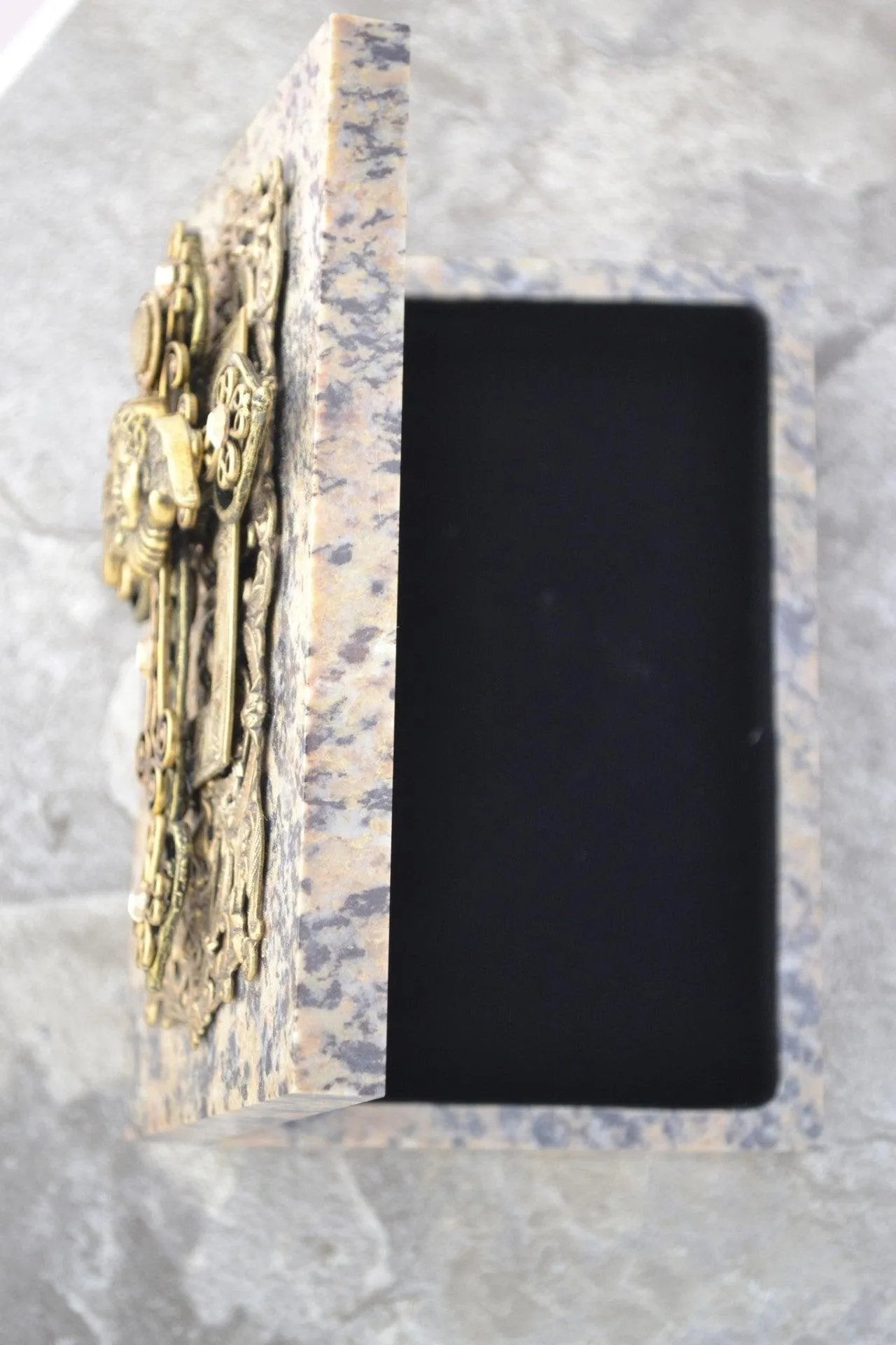Handcrafted soapstone keepsake box with angel and cross design, open with black interior