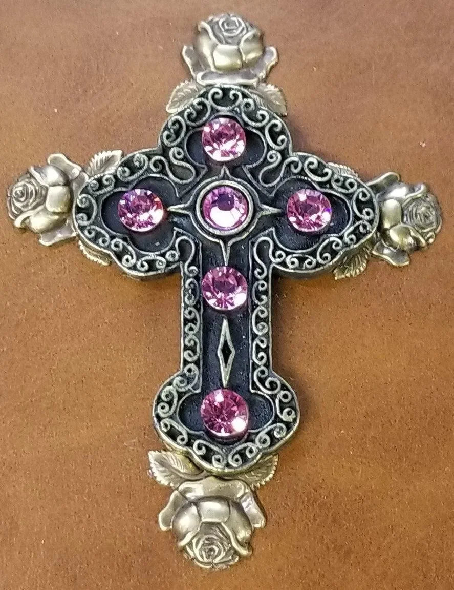 Close-up of ornate cross with pink gems and rose details on a keepsake Bible cover