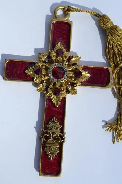 Vintage jeweled cross ornament with red stones, gold accents, and a gold tassel