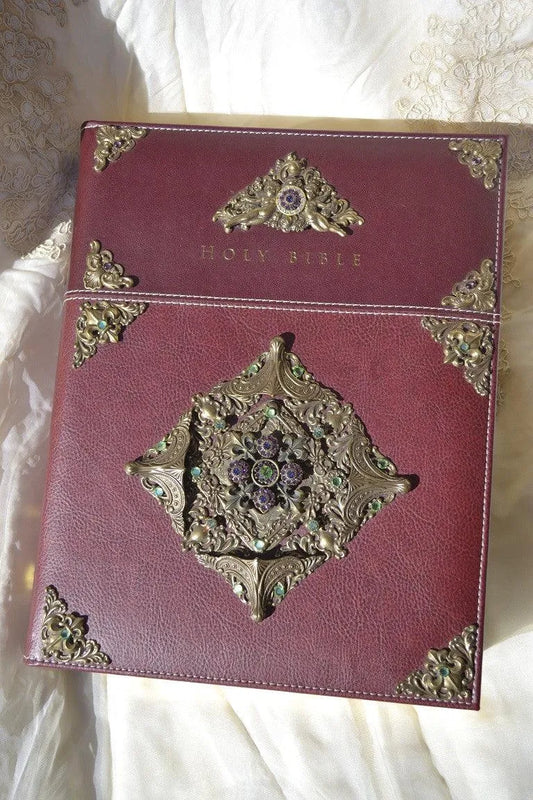 Jeweled leather family Bible with ornate gold corner designs and gemstone embellishments
