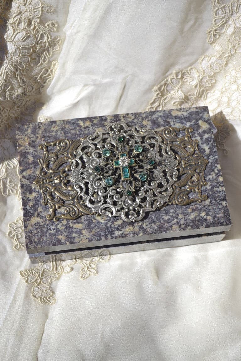 Ornate green soapstone keepsake box with decorative metal and gemstone cross design on lid