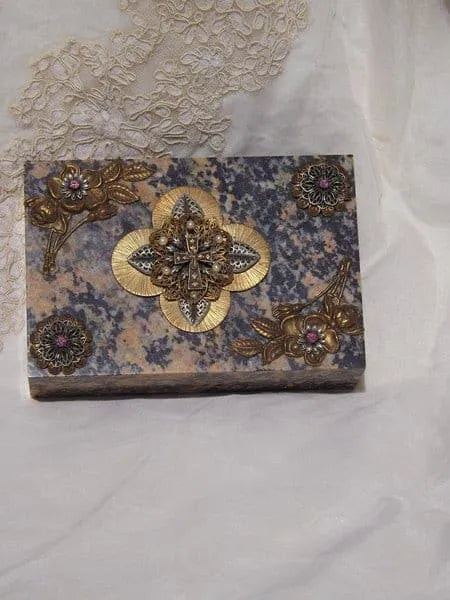 Handcrafted soapstone keepsake box with ornate floral metal embellishments on lid