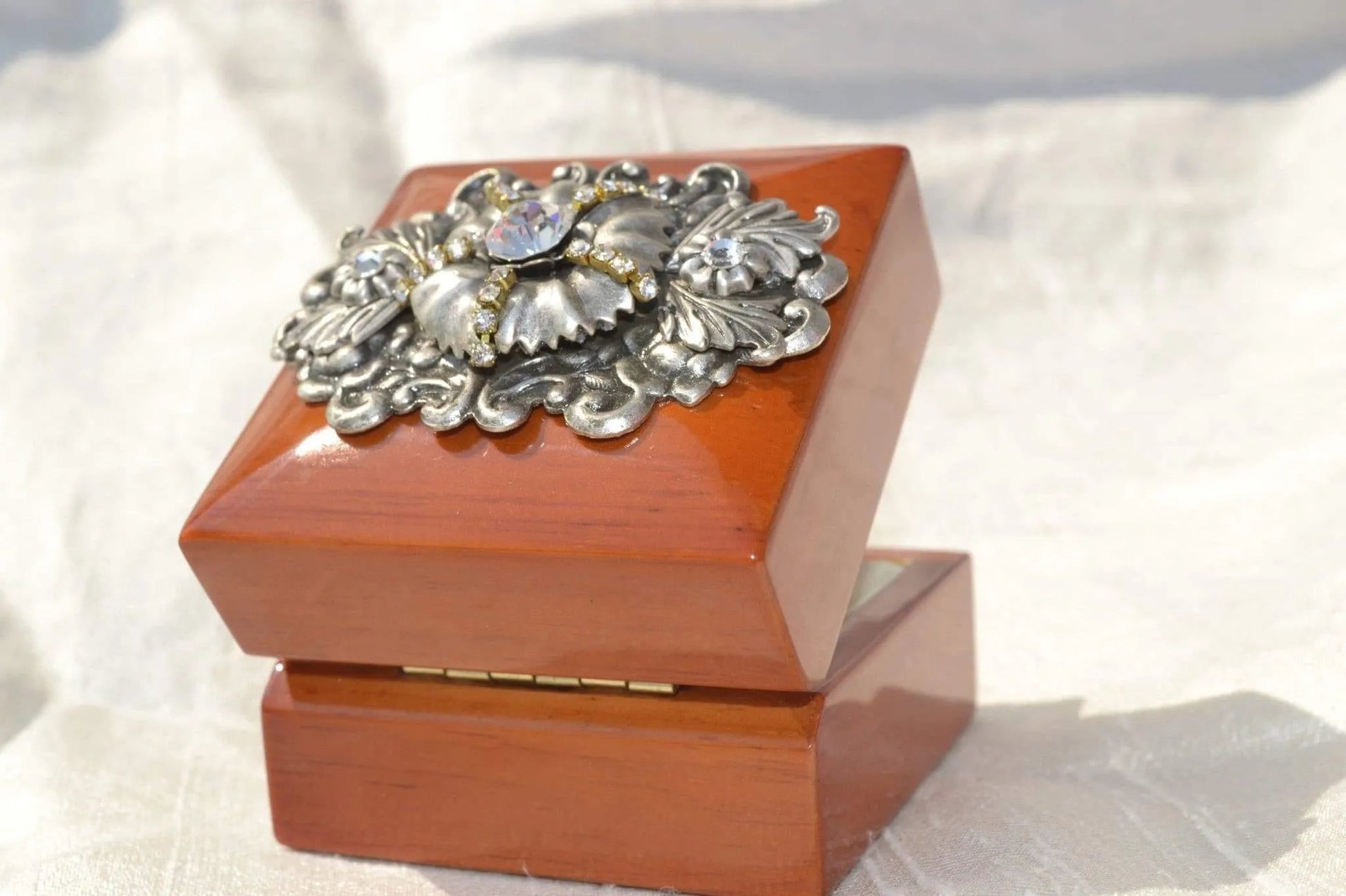 Handcrafted wood ring box with ornate silver floral and gemstone decoration, side open