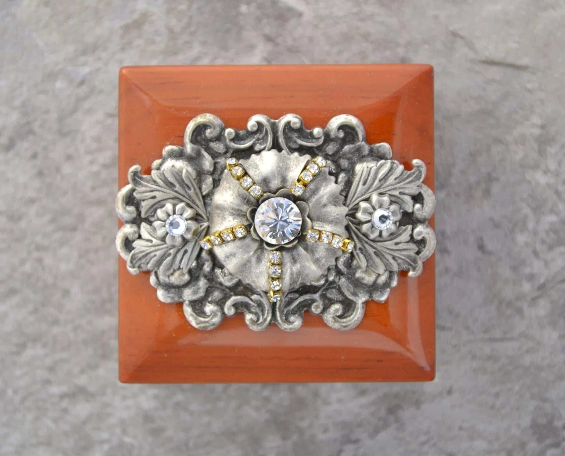 Handcrafted wood ring box with ornate silver floral design and gemstone accents on lid
