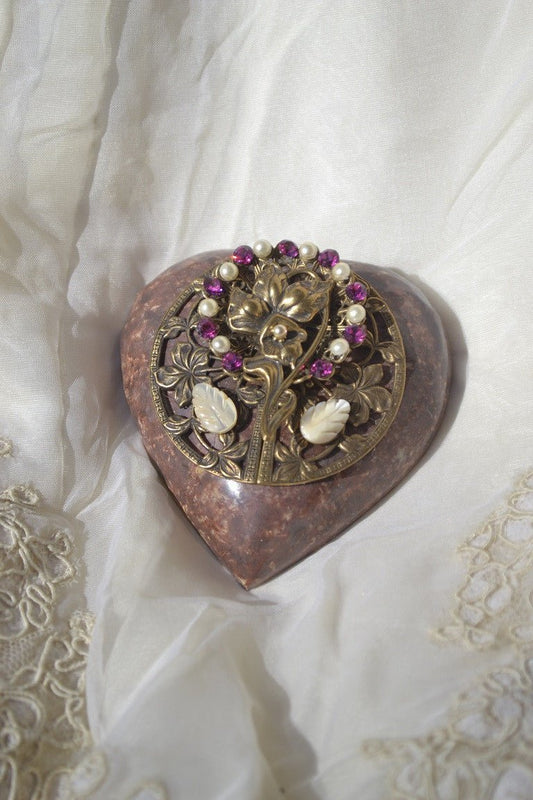 Heart-shaped paperweight with ornate gold floral design, magenta gems, and pearl beads.