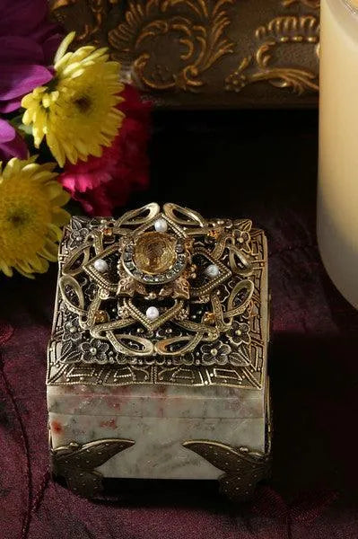 Ornate vintage jeweled butterfly ring box with gemstone accents and intricate metal design