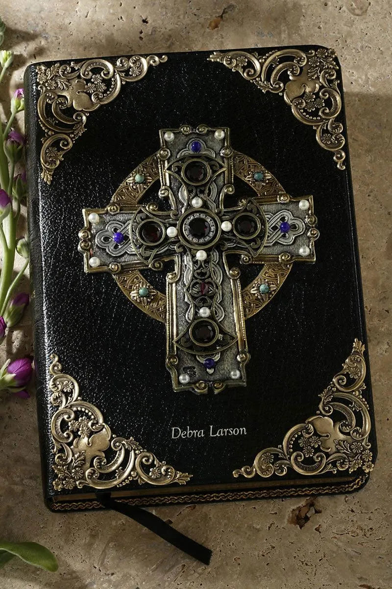Black leather Bible with jeweled Celtic cross and ornate gold corner designs