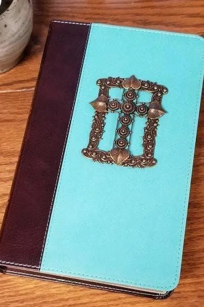 Jeweled KJV Bible with teal cover and ornate brass cross, giant print edition on wood surface