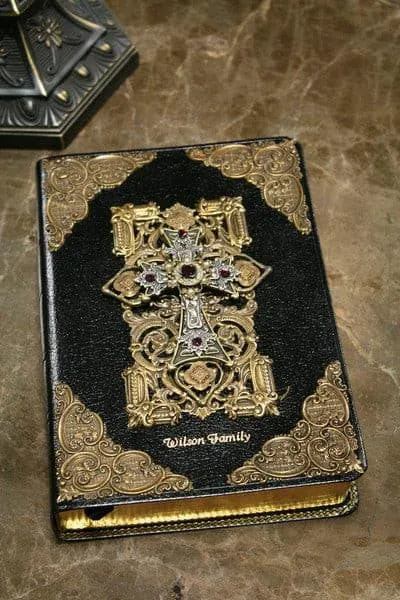 Jeweled KJV Bible with amethyst stones, ornate gold corners, and decorative cross on black cover