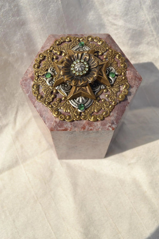 Hexagonal keepsake box with ornate jeweled Maltese cross metal lid on marble base