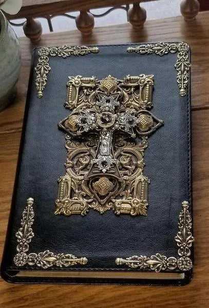 Handcrafted black Bible with ornate jeweled cross and amethyst crystal accents on cover