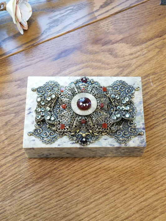 Jeweled soapstone keepsake box with ornate metal filigree and colorful gemstones on lid