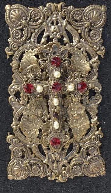 Jeweled Catholic Bible cover with ornate metal cross, red gemstones, and intricate floral details